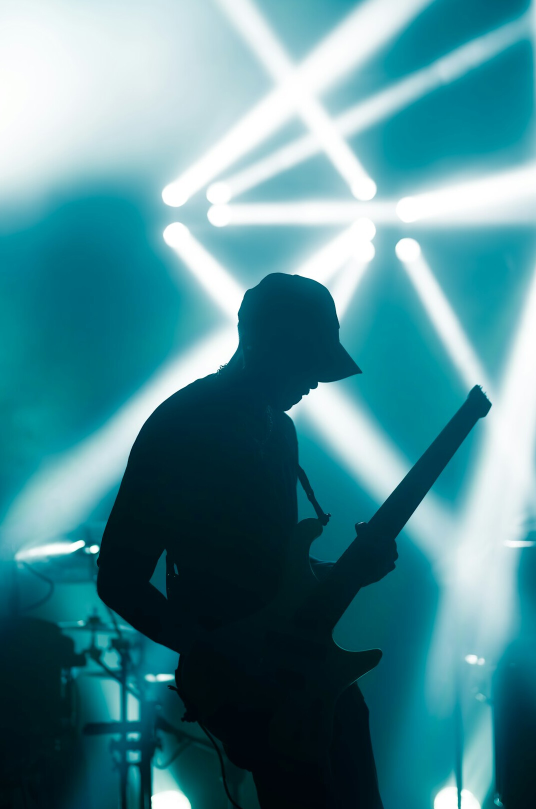 Musician silhouette performing on stage with lights