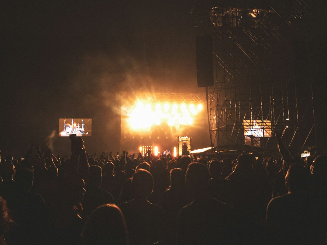 Concert crowd with warm stage lights at night